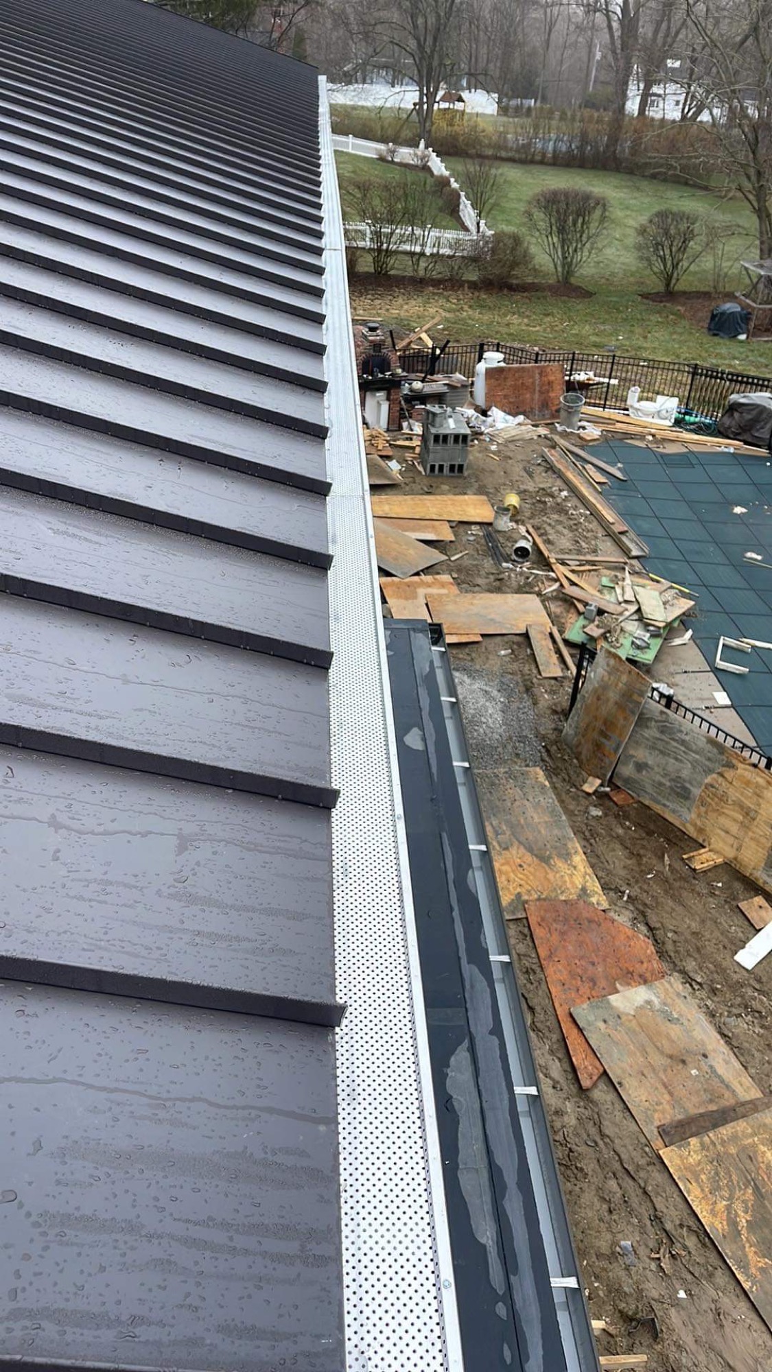 Standing seam metal roof with new gutter and gutter guard